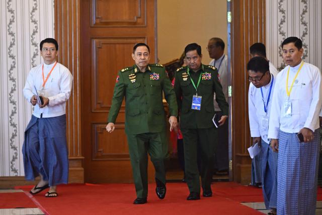 Myanmar's Defence Minister Yar Pyae (C) arrives to attend a ceremony marking the 11th anniversary of the signing of the Nationwide Ceasefire Agreement (NCA) in Naypyidaw on October 15, 2026, amid the ongoing civil war that has killed an estimated 100,000 people since 2021. Myanmar marked on October 15 the 11th anniversary of the Nationwide Ceasefire Agreement (NCA), which brokered peace with some of the countrys myriad armed factions in 2015. A number of groups pulled out of the landmark deal in the wake of the 2021 military coup which unleashed a full-blown civil war. The government presents the faltering agreement as a path to new peace talks, but many of the most powerful armed factions refuse to engage. (Photo by SAI AUNG MAIN / AFP)