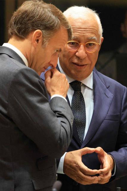 France's President Emmanuel Macron (L) and European Council President Antonio Costa speak together ahead of a round table as part of a European Union summit at the EU headquarters in Brussels on October 15, 2026. EU leaders head on October 15, 2026 for their biggest clash yet over the bloc's next long-term budget, as they race to lock in a deal before next year's French presidential election. (Photo by Ludovic MARIN / AFP)