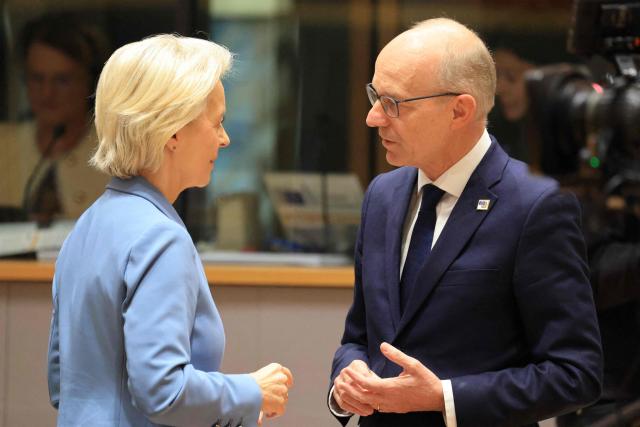 European Commission President Ursula von der Leyen (L) and Luxembourg's Prime Minister Luc Frieden speak together ahead of a round table as part of a European Union summit at the EU headquarters in Brussels on October 15, 2026. EU leaders head on October 15, 2026 for their biggest clash yet over the bloc's next long-term budget, as they race to lock in a deal before next year's French presidential election. (Photo by Ludovic MARIN / AFP)