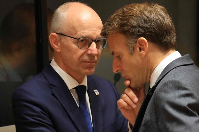 Luxembourg's Prime Minister Luc Frieden (L) and France's President Emmanuel Macron speak together ahead of a round table as part of a European Union summit at the EU headquarters in Brussels on October 15, 2026. EU leaders head on October 15, 2026 for their biggest clash yet over the bloc's next long-term budget, as they race to lock in a deal before next year's French presidential election. (Photo by Ludovic MARIN / AFP)