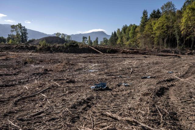 This photograph shows a large area of forest cleared for the construction of the controversial A412 motorway, near Perrignier, Haute-Savoie, France, on October 14, 2026. A coalition of associations, farmers, and residents on October 14, 2026, sought to halt construction of the A412 motorway, arguing that its environmental impact runs “counter to the climate emergency.” While a court ruling is expected on October 15, 2026, protesters have staged near-daily demonstrations, resulting in dozens of detentions and fines, according to organizers. (Photo by Fabrice COFFRINI / AFP)