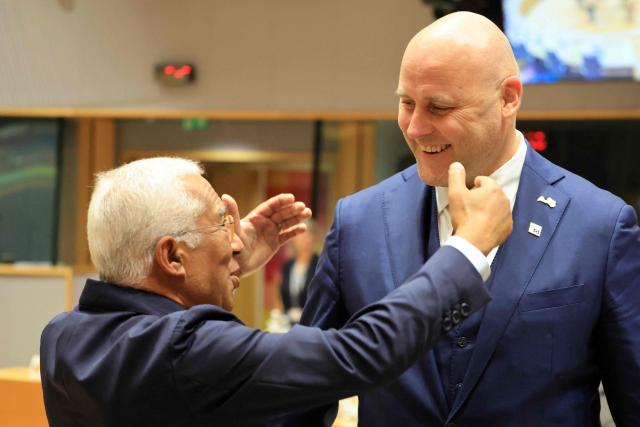 European Council President Antonio Costa (L) greets Latvia's Prime Minister Andris Kulbergs ahead of a round table as part of a European Union summit at the EU headquarters in Brussels on October 15, 2026. EU leaders head on October 15, 2026 for their biggest clash yet over the bloc's next long-term budget, as they race to lock in a deal before next year's French presidential election. (Photo by Ludovic MARIN / AFP)