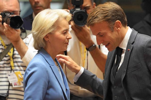 European Commission President Ursula von der Leyen (L) and France's President Emmanuel Macron speak together ahead of a round table as part of a European Union summit at the EU headquarters in Brussels on October 15, 2026. EU leaders head on October 15, 2026 for their biggest clash yet over the bloc's next long-term budget, as they race to lock in a deal before next year's French presidential election. (Photo by Ludovic MARIN / AFP)