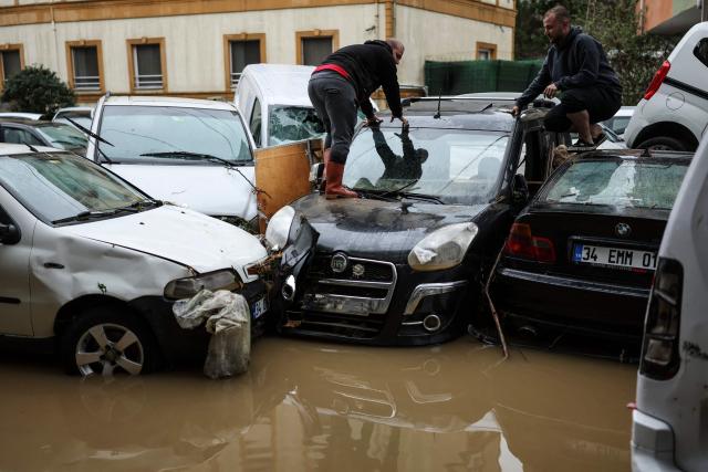 Car owners search for their vehicles swept away by the flood after a heavy rain at Ayazaga district in Istanbul, on October 15,2026. Istanbul was on October 15, 2026 battling to recover from flooding caused by what officials said was the heaviest rainfall in the city since records began more than 80 years ago, as the downpour continued. The rain began lashing Turkey's largest city in earnest on October 14, 2026 morning and intensified throughout the day, causing chaos and flash flooding, with footage showing cars being dragged away by the fast-flowing waters. (Photo by BERK OZKAN / AFP)