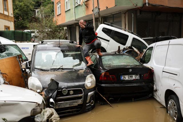 A car owner searches for his vehicle swept away by the flood after a heavy rain at Ayazaga district in Istanbul, on October 15,2026. Istanbul was on October 15, 2026 battling to recover from flooding caused by what officials said was the heaviest rainfall in the city since records began more than 80 years ago, as the downpour continued. The rain began lashing Turkey's largest city in earnest on October 14, 2026 morning and intensified throughout the day, causing chaos and flash flooding, with footage showing cars being dragged away by the fast-flowing waters. (Photo by BERK OZKAN / AFP)