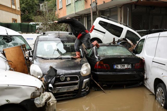 A car owner searches for his vehicle swept away by the flood after a heavy rain at Ayazaga district in Istanbul, on October 15,2026. Istanbul was on October 15, 2026 battling to recover from flooding caused by what officials said was the heaviest rainfall in the city since records began more than 80 years ago, as the downpour continued. The rain began lashing Turkey's largest city in earnest on October 14, 2026 morning and intensified throughout the day, causing chaos and flash flooding, with footage showing cars being dragged away by the fast-flowing waters. (Photo by BERK OZKAN / AFP)