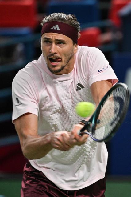 Germany's Alexander Zverev hits a return to Australia's Alex de Minaur during their men's singles quarter-final match at the Shanghai Masters tennis tournament in Shanghai on October 15, 2026. (Photo by Hector RETAMAL / AFP)