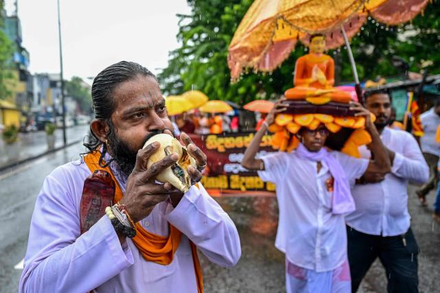A supporter blows a conch shell as Buddhist monks march to Sri Lankan President's office in Colombo on October 15, 2026 demanding a pardon for Galagodaatte Gnanasara, accused of fuelling anti-Muslim sentiment and religious tensions. (Photo by Ishara S. KODIKARA / AFP)