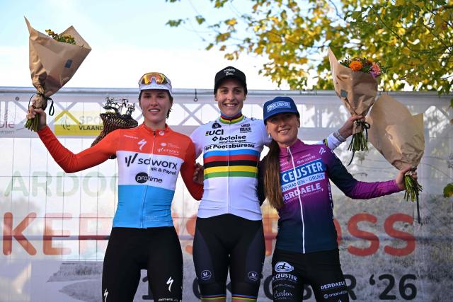 (From L) Second placed Luxembourg's rider Marie Schreiber, winner Netherlands' rider Lucinda Brand and third placed Netherlands' rider Denise Betsema celebrate on the podium of the women's elite race of the 'Kermiscross' cyclocross cycling event in Ardooie on October 15, 2026. (Photo by DAVID PINTENS / Belga / AFP) / Belgium OUT