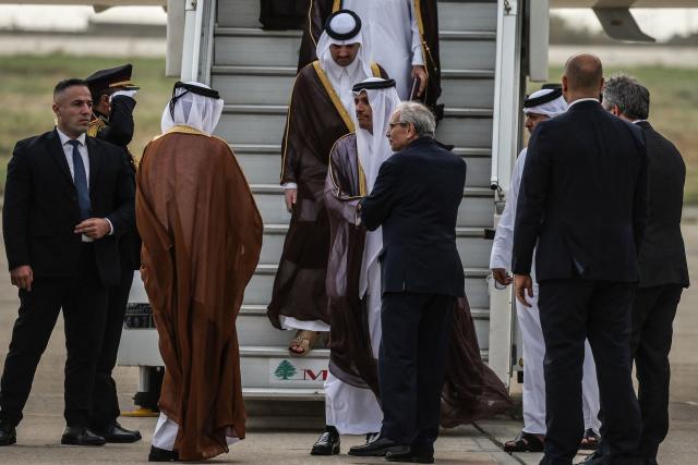 Qatar's Prime Minister and Foreign Minister Sheikh Mohammed bin Abdulrahman bin Jassim Al-Thani (C-L) is greeted by Lebanese Prime Minister Nawaf Salam as he arrives at Beirut-Rafic Hariri International Airport during an official visit to Lebanon on October 15, 2026. (Photo by Anwar AMRO / AFP)