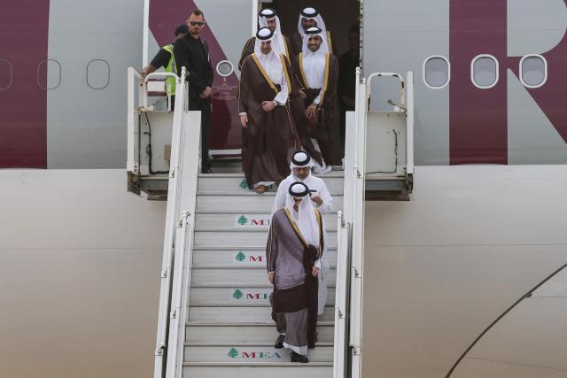 Qatar's Prime Minister and Foreign Minister Sheikh Mohammed bin Abdulrahman bin Jassim Al-Thani (front) with his delegation disembarks upon arrival at  Beirut-Rafic Hariri International Airport during an official visit to Lebanon on October 15, 2026. (Photo by Anwar AMRO / AFP)
