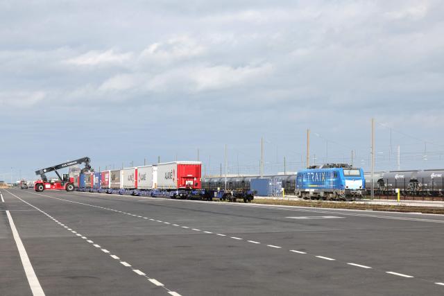 This photographs shows a container-handling truck loading a train at the Port of Dunkirk’s new intermodal rail terminal during it's inauguration, in Loon-Plage near Dunkirk on October 15, 2026. (Photo by Francois LO PRESTI / AFP)
