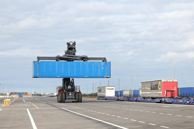 This photographs shows a container-handling truck loading a train at the Port of Dunkirk’s new intermodal rail terminal during it's inauguration, in Loon-Plage near Dunkirk on October 15, 2026. (Photo by Francois LO PRESTI / AFP)