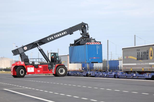 This photographs shows a container-handling truck loading a train at the Port of Dunkirk’s new intermodal rail terminal during it's inauguration, in Loon-Plage near Dunkirk on October 15, 2026. (Photo by Francois LO PRESTI / AFP)