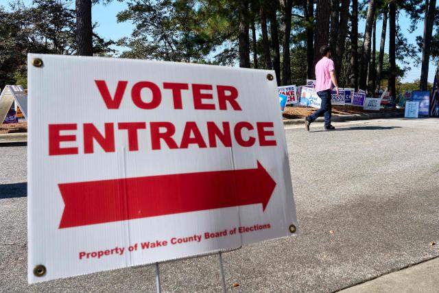 A sign guides voters to the entrance of the NC State University Business Services building on the first day of early voting in Raleigh, North Carolina on October 15, 2026. Americans voting in the November 3 midterm elections will decide who controls Congress for the final two years of Donald Trump's presidency, along with dozens of governorships and thousands of state offices. (Photo by Matt RAMEY / AFP)