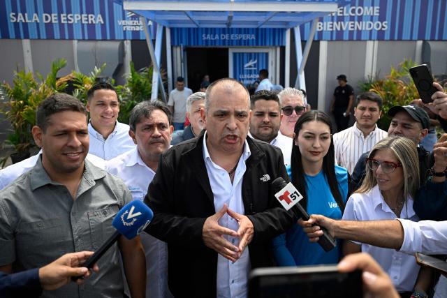 Gustavo Ruiz, state coordinator in Zulia for Vente Venezuela, the party led by opposition leader Maria Corina Machado, speaks to reporters upon his arrival at Simon Bolivar International Airport in Maiquetia, La Guaira state, Venezuela, on October 15, 2026, after a period in exile. (Photo by Federico PARRA / AFP)