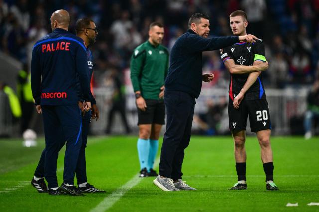 Crystal Palace's French coach Pierre Sage speaks with Crystal Palace's English midfielder #20 Adam Wharton during the UEFA Europa League, league phase matchday 2, football match between Olympique Lyonnais and Crystal Palace at the Groupama Stadium in Decines-Charpieu, near Lyon, on October 15, 2026. (Photo by OLIVIER CHASSIGNOLE / AFP)