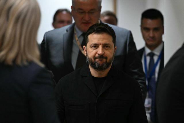 Ukraine's Foreign Minister Andriy Sybiga (C) and Ukraine's President Volodymyr Zelensky arrive to attend a bilateral meeting with Poland's Prime Minister Donald Tusk (unseen) on the sidelines of an EU summit in Brussels on October 15, 2026. EU leaders head on October 15, 2026 for their biggest clash yet over the bloc's next long-term budget, as they race to lock in a deal before next year's French presidential election as Zelensky holds a string of bilateral talks with European leaders before joining an EU summit tomorrow. (Photo by NICOLAS TUCAT / POOL / AFP)
