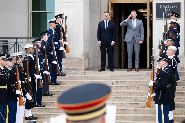 US Secretary of Defense Pete Hegseth salutes during a welcoming ceremony ahead of a meeting with UK Defense Secretary Wes Streeting (L) at the Pentagon in Washington, DC on October 15, 2026. (Photo by SAUL LOEB / AFP)