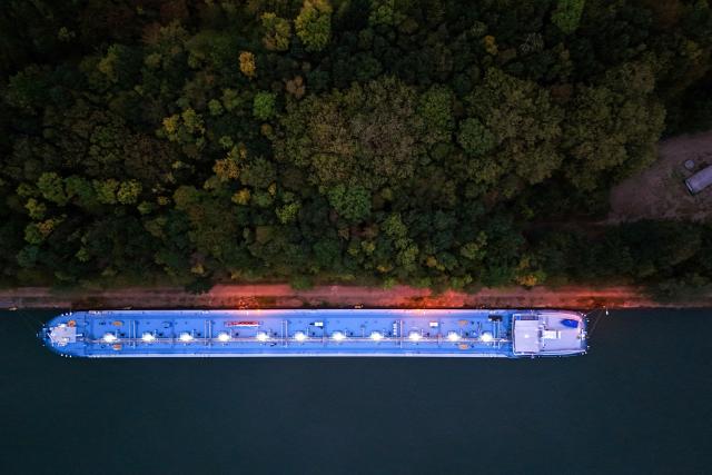 An aerial view shows a vessel near the fuel depot of Aral at the Ruhr Oel petroleum refineries of BP Gelsenkirchen GmbH in Gelsenkirchen, western Germany on October 15, 2026. Ruhr Oel Gelsenkirchen refinery is one of the key production sites for fuels such as kerosene and diesel in Germany. (Photo by Ina FASSBENDER / AFP)