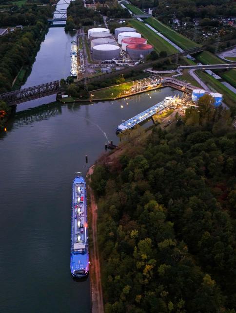 An aerial view shows vessels near the fuel depot of Aral at the Ruhr Oel petroleum refineries of BP Gelsenkirchen GmbH in Gelsenkirchen, western Germany on October 15, 2026. Ruhr Oel Gelsenkirchen refinery is one of the key production sites for fuels such as kerosene and diesel in Germany. (Photo by Ina FASSBENDER / AFP)