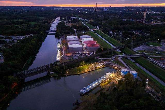 An aerial view shows vessels near the fuel depot of Aral at the Ruhr Oel petroleum refineries of BP Gelsenkirchen GmbH in Gelsenkirchen, western Germany on October 15, 2026. Ruhr Oel Gelsenkirchen refinery is one of the key production sites for fuels such as kerosene and diesel in Germany. (Photo by Ina FASSBENDER / AFP)