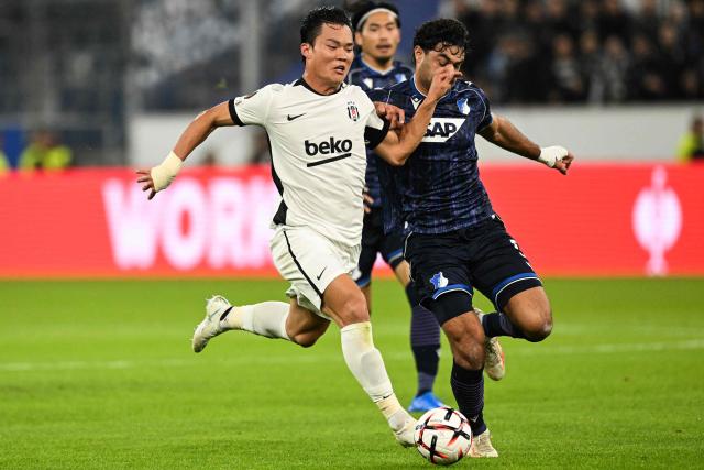 Hoffenheim's Turkish defender #05 Ozan Kabak (R) and Besiktas' South Korean forward #09 Hyeongyu Oh vie for the ball during the UEFA Europa League football match between Hoffenheim and Besiktas in Sinsheim, on October 15, 2026. (Photo by THOMAS KIENZLE / AFP)