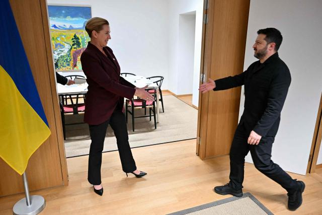 Ukraine's President Volodymyr Zelensky (R) shakes hands with Denmarks Prime Minister Mette Frederiksen (L) ahead of their bilateral meeting on the sidelines of an EU summit in Brussels on October 15, 2026. EU leaders head on October 15, 2026 for their biggest clash yet over the bloc's next long-term budget, as they race to lock in a deal before next year's French presidential election as Zelensky holds a string of bilateral talks with European leaders before joining an EU summit tomorrow. (Photo by NICOLAS TUCAT / POOL / AFP)