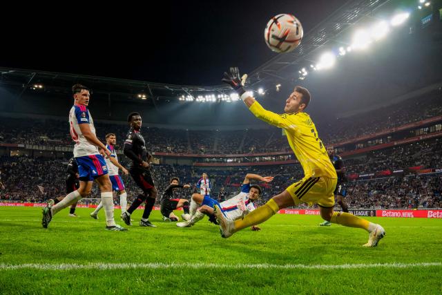 Crystal Palace's goalkeeper #44 Walter Benitez (R) stretches for the ball as Crystal Palace’s Japanese midfielder #18 Daichi Kamada (C) scores Crystal Palace's second goal during the UEFA Europa League, league phase matchday 2, football match between Olympique Lyonnais and Crystal Palace at the Groupama Stadium in Decines-Charpieu, near Lyon, on October 15, 2026. (Photo by OLIVIER CHASSIGNOLE / AFP)