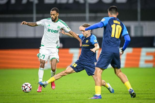 Celje's defender #44 Lukasz Bejger (C) tackles Omonia's forward #07 Jaden Montnor (L) as Celje's midfielder #10 Svit Seslar (R) looks on during the UEFA Europa League, league phase matchday 2, football match between NK Celje and Omonoia at the Stadion Z'dezele in Celje, on October 15, 2026. (Photo by Jure Makovec / AFP)
