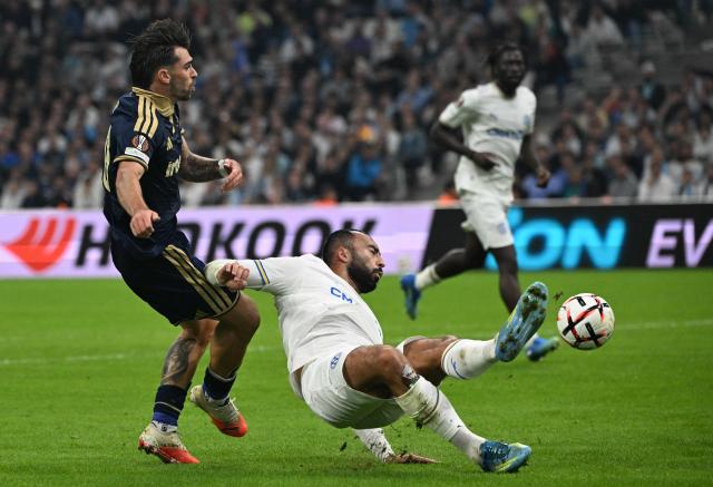 Marseille's midfielder #08 Himad Abdelli (C) and Olympiacos' forward #20 Joao Silva (L) fight for the ball during the UEFA Europa League, league phase matchday 2, football match between Olympique de Marseille and Olympiacos at the Stade Velodrome in Marseille, on October 15, 2026. (Photo by Miguel MEDINA / AFP)