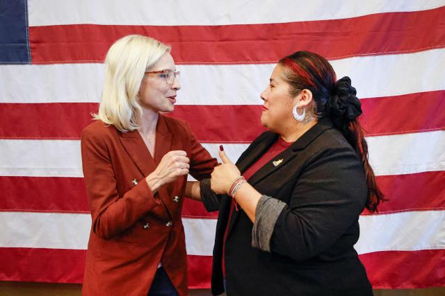 US representative Ashley Hinson (R-IA), candidate for US Senate in Iowa, speaks with a supporter during a campaign stop in Davenport, Iowa on October 15, 2026. Hinson, is running to replace the retiring US Senator Joni Ernst. Americans voting in the November 3 midterm elections will decide who controls Congress for the final two years of Donald Trump's presidency, along with dozens of governorships and thousands of state offices. (Photo by KAMIL KRZACZYNSKI / AFP)