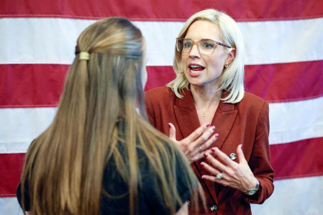 US representative Ashley Hinson (R-IA), candidate for US Senate in Iowa, speaks with a supporter during a campaign stop in Davenport, Iowa on October 15, 2026. Hinson, is running to replace the retiring US Senator Joni Ernst. Americans voting in the November 3 midterm elections will decide who controls Congress for the final two years of Donald Trump's presidency, along with dozens of governorships and thousands of state offices. (Photo by KAMIL KRZACZYNSKI / AFP)