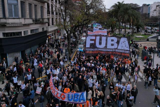 Students, lecturers and university workers march during a demonstration demanding that the government of Argentine President Javier Milei comply with a law updating funding for public universities, in Buenos Aires, on October 15, 2026. (Photo by Emiliano LASALVIA / AFP)