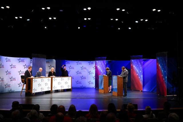 US Senator Susan Collins (R-ME) and Democratic candidate for US Senate Troy Jackson take notes during their debate at the Gracie Theatre in Bangor, Maine on October 15, 2026. Jackson is looking to unseat the five-term senator in November's midterm election. Americans voting in the November 3 midterm elections will decide who controls Congress for the final two years of Donald Trump's presidency, along with dozens of governorships and thousands of state offices. (Photo by CHARLY TRIBALLEAU / AFP)