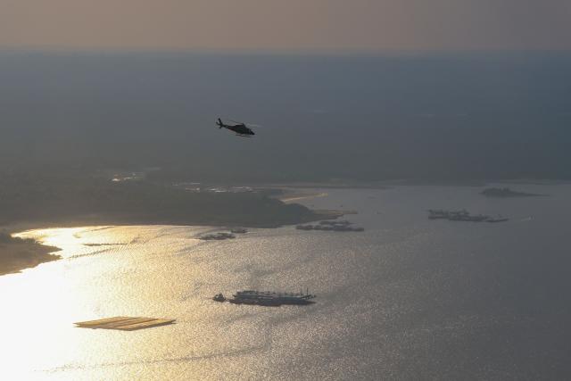 IBAMA helicopters are seen flying over the Rio Negro, near Manaus, in the state of Amazonas, northern Brazil, on October 15, 2026. (Photo by MICHAEL DANTAS / AFP)