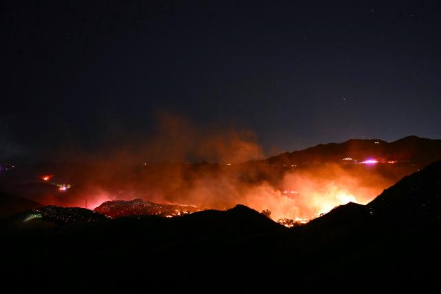 The Bryson Fire burns in Malibu, California on October 15, 2026. The brush fire in the mountains west of Los Angeles prompted evacuation warnings from officials, as powerful Santa Ana winds risked spreading the blaze rapidly. (Photo by Patrick T. Fallon / AFP)