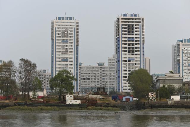North Korean buildings in the town of Sinuiju are seen from the border city of Dandong, in China's northeast Liaoning province, on October 15, 2026.  (Photo by Michael ZHANG / AFP)