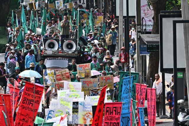 Demonstrators march during a protest against the International Monetary Fund (IMF) and World Bank Group in Bangkok on October 16, 2026, as the IMF Annual Meetings take place in the Thai capital. (Photo by ANTHONY WALLACE / AFP)