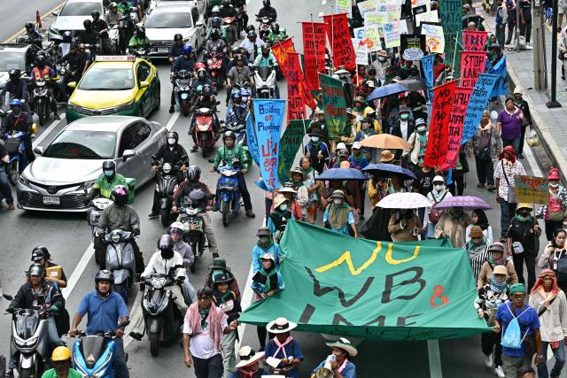 Demonstrators march during a protest against the International Monetary Fund (IMF) and World Bank Group in Bangkok on October 16, 2026, as the IMF Annual Meetings take place in the Thai capital. (Photo by ANTHONY WALLACE / AFP)