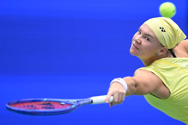 Russia's Diana Shnaider hits a return to Latvia's Jelena Ostapenko during their women's singles quarter final match at the Wuhan Open tennis tournament in Wuhan, China's Hubei province on October 16, 2026. (Photo by WANG Zhao / AFP)