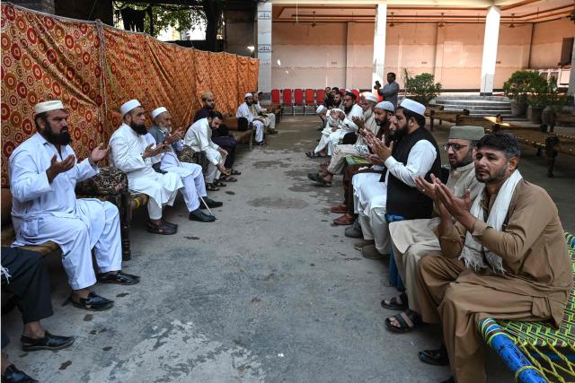 People pray for students killed after a roof collapsed at a school, in Peshawar on October 16, 2026. The roof of a school collapsed in Pakistan's northwestern city of Peshawar on October 16, killing 32 students mostly younger than 14, and a teacher, officials said, blaming the accident on dilapidated infrastructure. (Photo by Abdul MAJEED / AFP)