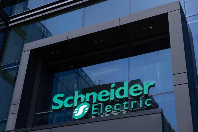 (FILES) This photograph taken on May 3, 2023, shows the headquarters of French electrical equipment giant Schneider Electric and its logo, in Rueil-Malmaison, outside Paris. French electrical equipment giant Schneider Electric announced on October 16, 2026 “record” third-quarter revenue, up 17.9% to 11.5 billion euros, and raised its financial targets for 2026. (Photo by JOEL SAGET / AFP)