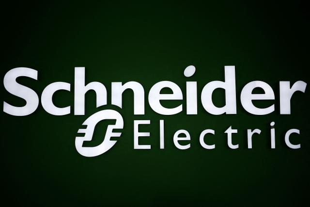 (FILES) This picture taken on February 21, 2019 shows a logo of French electrical equipment giant Schneider Electric in its 4.0 production plant in Le Vaudreuil, northwestern France. French electrical equipment giant Schneider Electric announced on October 16, 2026 “record” third-quarter revenue, up 17.9% to 11.5 billion euros, and raised its financial targets for 2026. (Photo by CHARLY TRIBALLEAU / AFP)