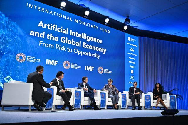 (L-R) CNN presenter Richard Quest, Co-founder and Head of Public Benefit of Anthropic Jack Clark, Bank of Canada Governor Tiff Macklem, IMF Managing Director Kristalina Georgieva, DHL Group CEO Tobias Meyer and CEO of Addo AI Ayesha Khanna converse during the AI and the Global Economy: From Risk to Opportunity panel at the Annual Meetings of the International Monetary Fund (IMF) and the World Bank Group (WBG) at the Queen Sirikit National Convention Center (QSNCC) in Bangkok on October 16, 2026. (Photo by Lillian SUWANRUMPHA / AFP)