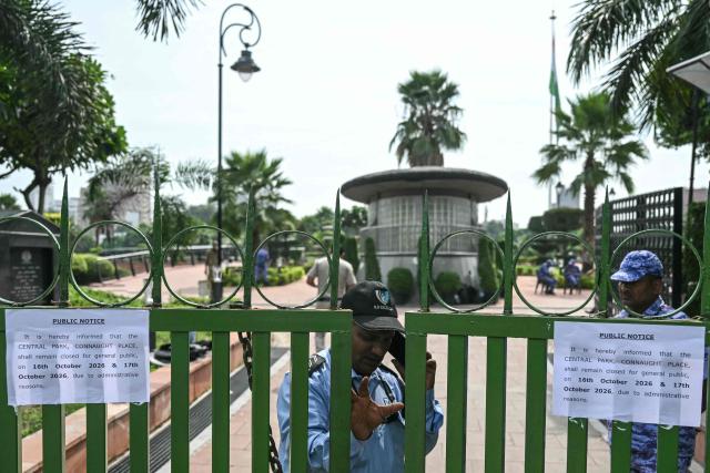 A security guard stands at the entrance of the closed central park at Connaught Place in New Delhi on October 16, 2026 ahead of a protest by the Cockroach Janta Party (CJP) demanding India's Chief Election Commissioner Gyanesh Kumar's resignation over alleged voter roll irregularities linked to the "special intensive revision" (SIR). Authorities closed a central New Delhi park October 16 before a fresh protest seeking the removal of India's election chief over a voter-roll revision that critics say has disenfranchised millions. (Photo by Arun SANKAR / AFP)