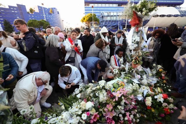 (FILES) People lay flowers and light candles in tribute to Mehdi Kessaci at the roundabout where he was murdered and to protest against drug trafficking, in Marseille, southern France on November 22, 2025. The trial of the alleged killers of the older brother of anti-drug trafficking activist Amine Kessaci and of two other young men, killed in December 2020, will take place in Aix-en-Provence from October 19 to November 6, 2026. (Photo by Clement MAHOUDEAU / AFP)