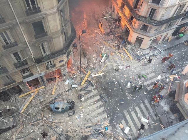 (FILES) A general view shows debris and car wreckage following the explosion of a bakery on the corner of the streets Saint-Cecile and Rue de Trevise in central Paris on January 12, 2019. Nearly eight years after the explosion on Rue de Trevise in Paris, which killed four people and injured more than 60, the City of Paris and the property manager of the building in question are facing charges of involuntary manslaughter and injury before the Paris Criminal Court in a trial expected to last from October 20 to December 7, 2026. (Photo by Carl LABROSSE / AFP)