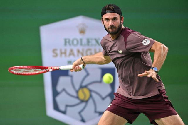USA's Tommy Paul hits a return to Russia's Daniil Medvedev during their men's singles quarter-final match at the Shanghai Masters tennis tournament in Shanghai on October 16, 2026. (Photo by Hector RETAMAL / AFP)