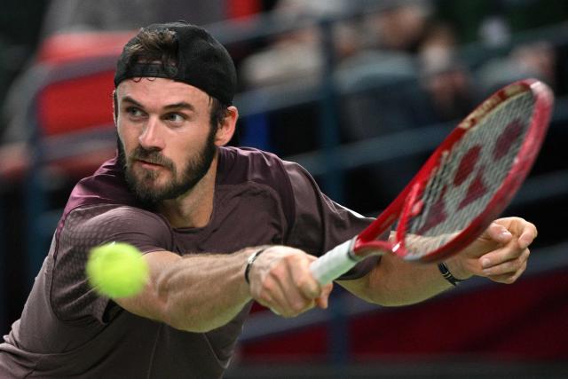 USA's Tommy Paul hits a return to Russia's Daniil Medvedev during their men's singles quarter-final match at the Shanghai Masters tennis tournament in Shanghai on October 16, 2026. (Photo by Hector RETAMAL / AFP)